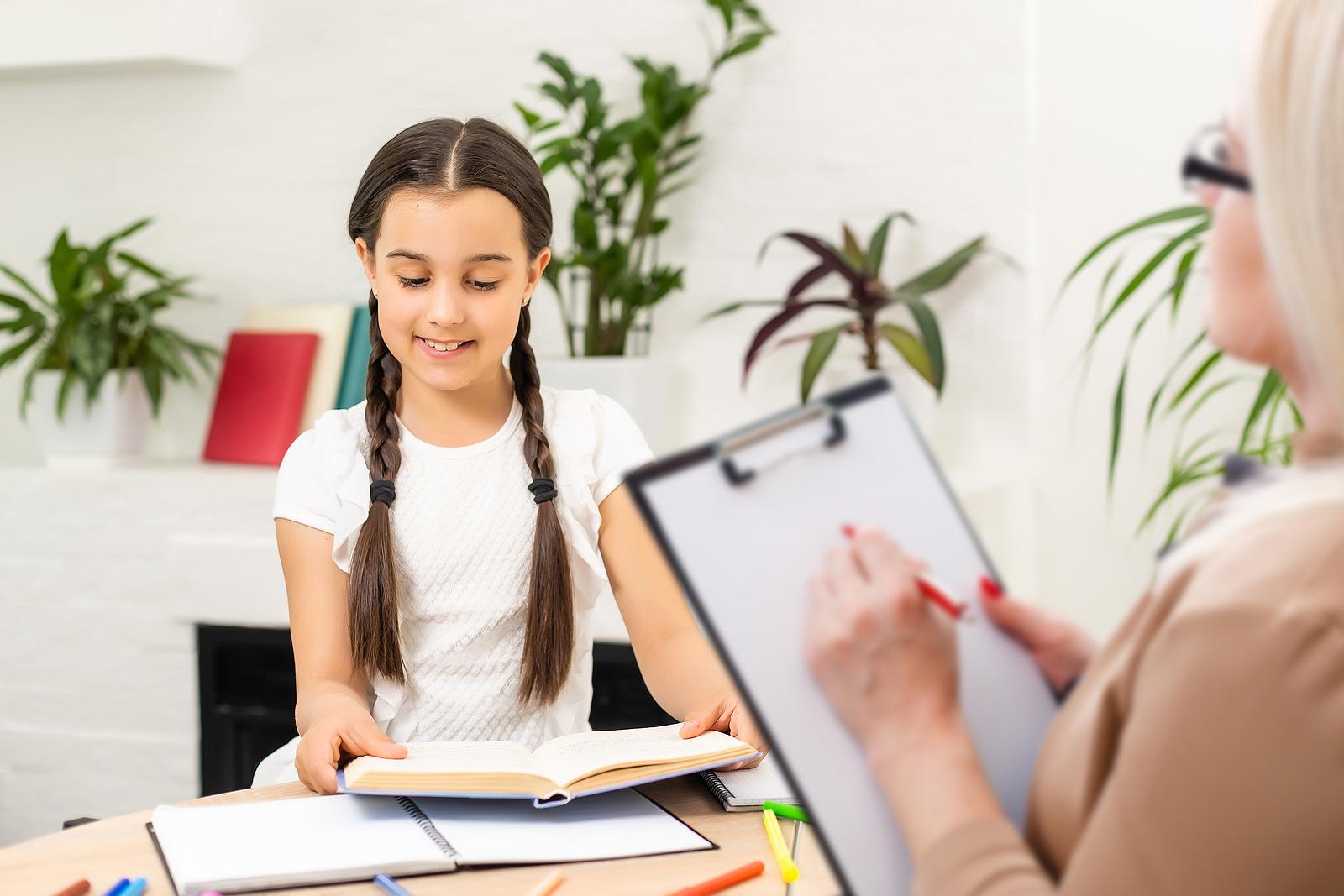 School psychologist meeting with students in a classroom setting.