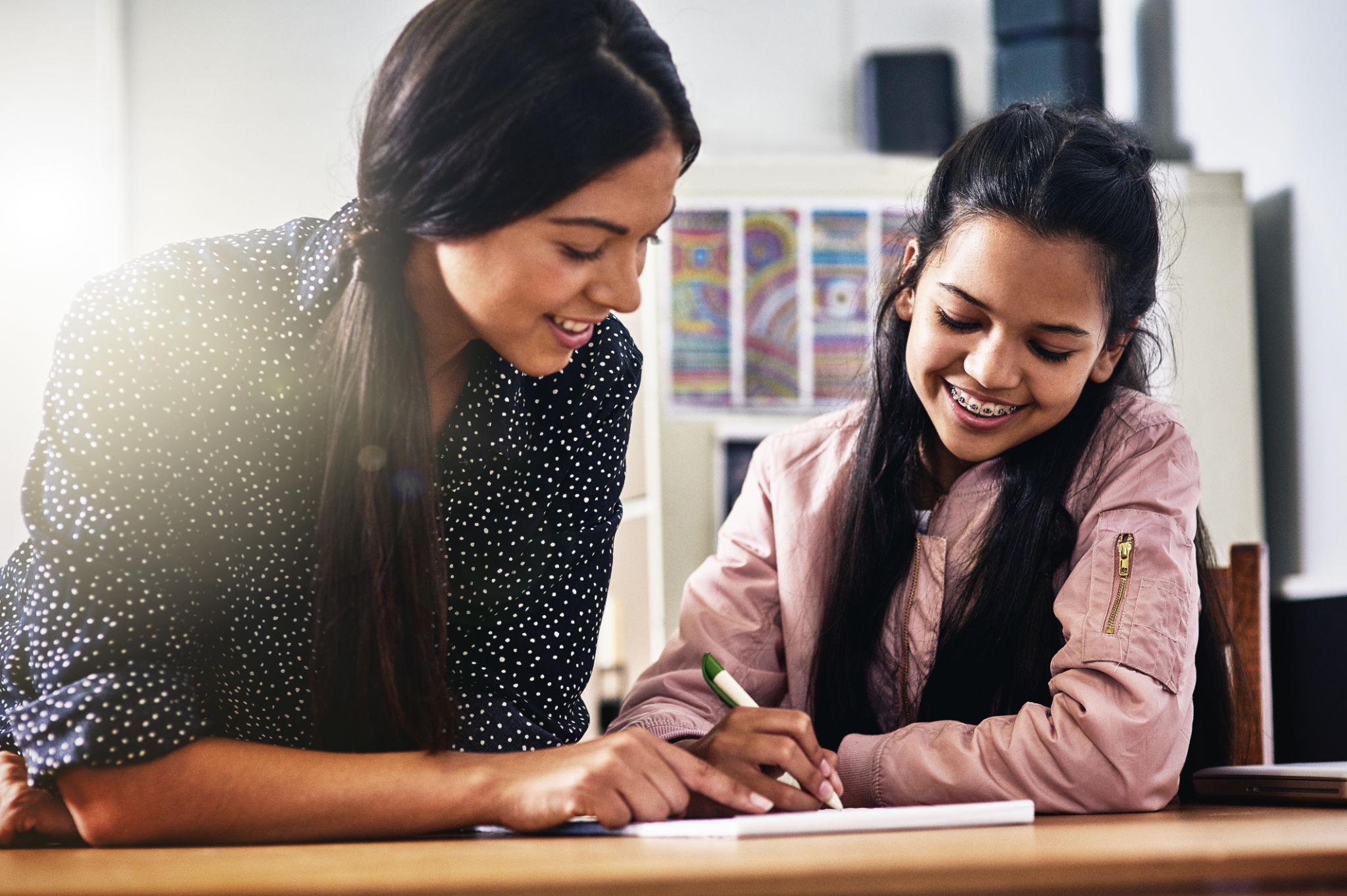 Teacher and student connecting in a classroom setting.